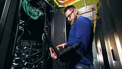 A programmer, IT specialist works with server computers.