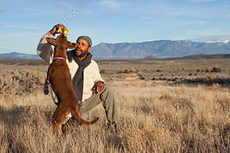 Man playing with his dog