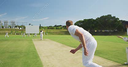 Rear view of cricket player throwing a ball