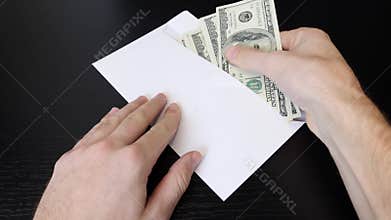 Hands put american one hundred dollar bills from envelope. Man holding cash money. Male counts dollars. Successful business concep