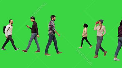 Different casual people walking by on a green screen, chroma key.