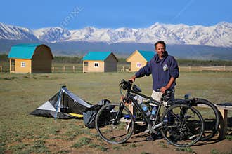 Brave bicyclist is ready to a long trip on a bicycle