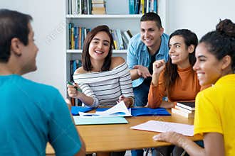 Laughing group of latin and caucasian and arabic students