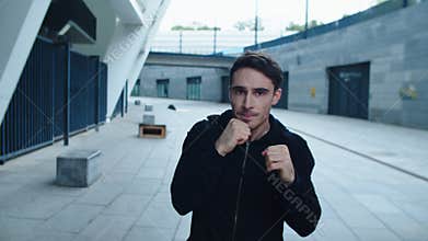 Portrait of young boxer training boxing exercise. Sportsman training punch