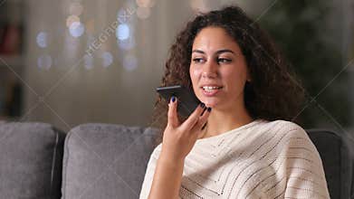 Happy arab woman using voice recognition on phone