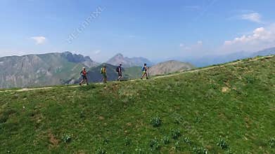 Group of tourists hiking on the mountain, walking, reached the top