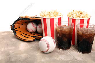 Popcorn on the table with softdrink cola. Baseball party food with balls for the playoffs