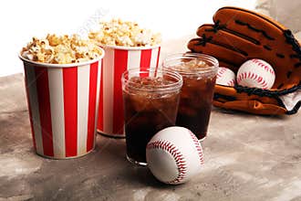Popcorn on the table with softdrink cola. Baseball party food with balls for the playoffs