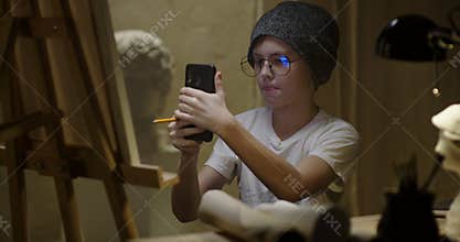 Boy painting on canvas