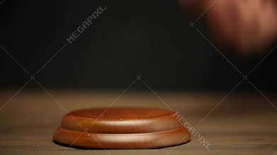 The judge strikes the gavel on the table. The verdict. For sale at auction.