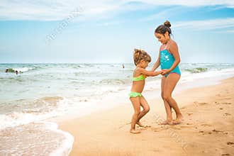 Two charming little girls in swimsuits