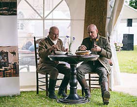 Retired soldiers in authentic outfit having lunch during national festival in Raudondvaris, Lithuania