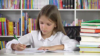 Student kid writing studying in library, child learning for school, girl doing homework at desk office at home