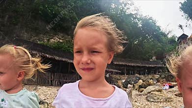 The sister's triplets stand in the wind and look ahead