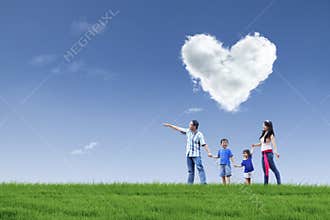 Happy family and cloud of love in park