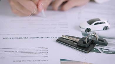 Buyers or sellers who are reading car lease or car insurance contract and signing. Sale agent deal to agreement car loan contract