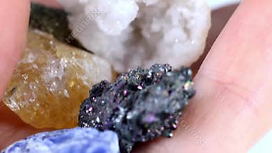 Different colorful semiprecious mineral crystal gemstones heap in the hand close up