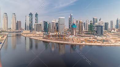 Cityscape with skyscrapers of Dubai Business Bay and water canal aerial timelapse.