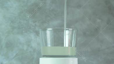 Xanthan gum dissolved in water is poured in thin stream into glass beaker. Food additive E415, natural gluten-free thickener