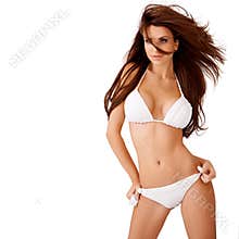 brunette with windblown hair in a bikini