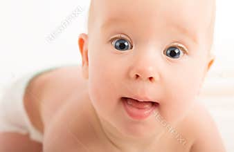 Beautiful happy baby with blue eyes