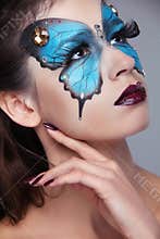 Fashion Make up. Butterfly makeup on face beautiful woman. Art P