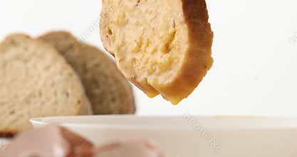 Slices of bread are soaked in beaten egg.