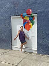 senior adult woman holding balloons