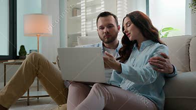 Caucasian couple using laptop app choose goods buying clothes in online web store internet shop shopping together