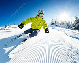 Skier on piste in high mountains