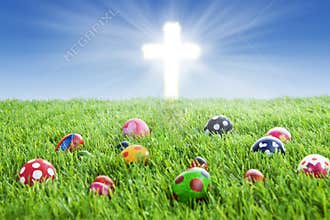Easter eggs and Cross on grass