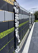 Elegant modern private house fence with ornaments of small white stones
