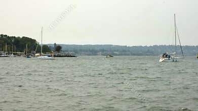Yachts sailing in the bay on a cloudy day. Boats on water