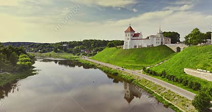 Flight and aerial panoramic view overlooking the old city and historic buildings of medieval castle over  wide river