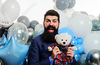 Happy bearded businessman in suit with teddy bear. Festive event. Handsome man celebrate birthday.