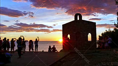 Sunset timelapse 4K with black silhouettes of people and lovers embraced