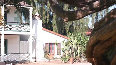 White mexican old house, window and garden, succulent cactus plant, California.