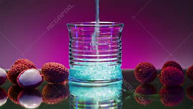 Juicy ripe lychee berries and the blue lagoon cocktail inside a glass. Stock clip. Concept of fun, party, night club and