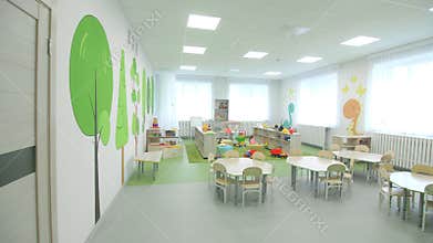Large tables for craft and racks with toys in playroom