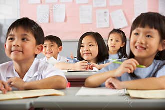 Students Working At Desks In Chinese School