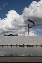 Vertical shot of the JK Memorial against fluffy clouds in Brasilia, Brazil