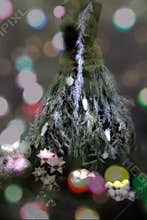 Christmas fir tree in dress shape and balls and stars - dress made from greenery and moss. Colorful dots