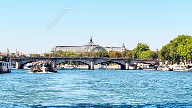 Concorde bridge and Grand Palais behind, with boat on Seine
