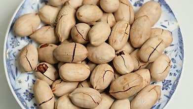 Overhead view of shelled pecans rotating. Natural snack, healthy food. Looped close-up rotation