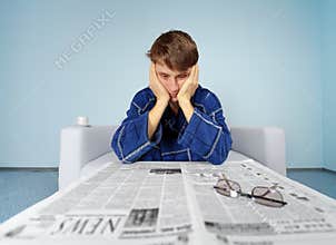 Man with newspaper - hard find a job