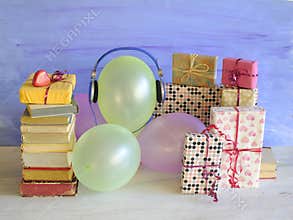 audio book as birthday gift with books,vintage headphones,balloons and decoration,free copy space