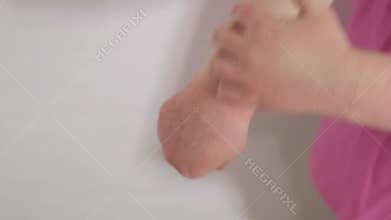 atopic dermatitis concept, girl scratches skin of her hands covered with rash, redness of the skin, allergy in child