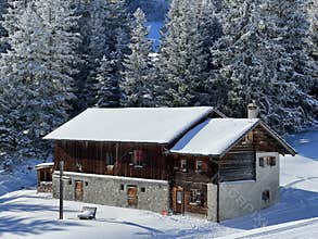 Old traditional swiss rural architecture and alpine livestock farms in the winter ambience of the resorts Valbella and Lenzerheid