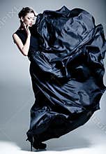 Beautiful woman model dressed in an elegant dress