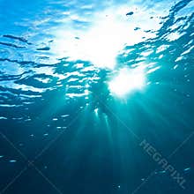 Sunrays breaking through the water surface